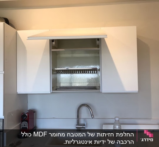 מטבח עם ארונות לבנים וברז מעל כיור